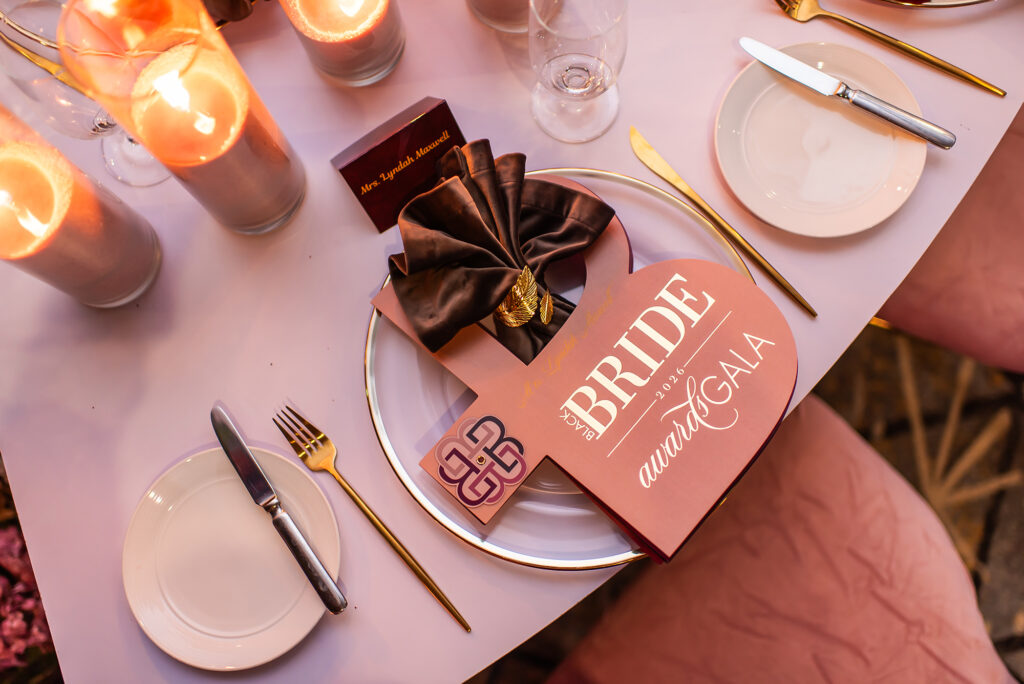 Custom Black Bride Gala menu with gold foil details and luxury table stationery by Sherry Green Designs featuring layered menu design, satin napkin styling, and elegant reception table details