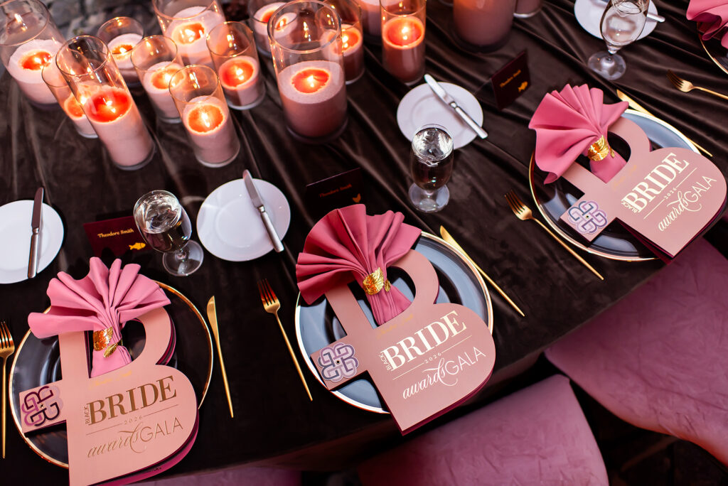 Custom Black Bride Gala menus with gold foil details and luxury table stationery by Sherry Green Designs featuring layered menu styling, blush napkins, and elegant gala table décor