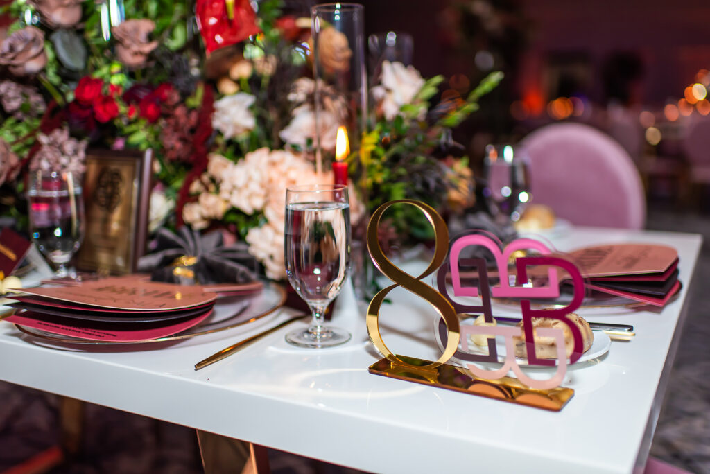 Luxury Black Bride Gala reception table featuring custom acrylic table number and acrylic logo signage by Sherry Green Designs, paired with elevated table stationery and elegant floral styling for planners and luxury events