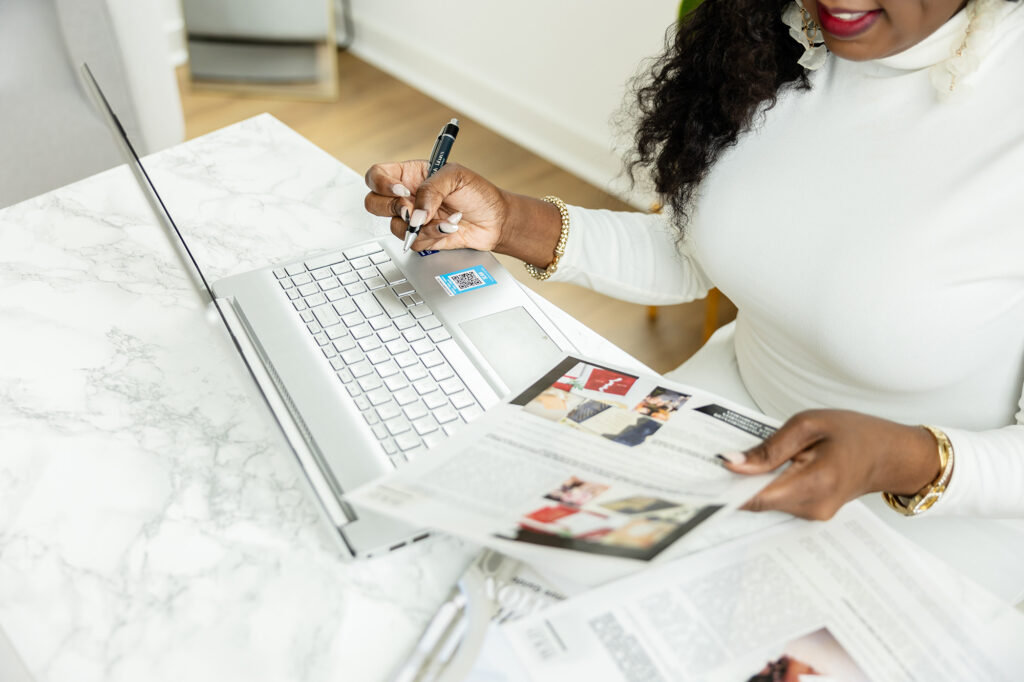 Sherry Green reviewing wedding stationery designs and client materials while planning luxury stationery details for couples and planners
