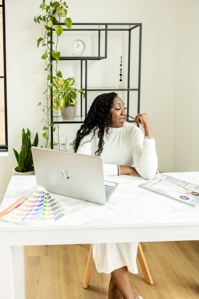 Sherry Green of Sherry Green Designs seated at her desk planning luxury wedding stationery and invitation designs for couples and wedding planners