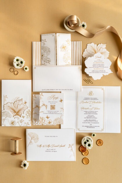 Elegant white and gold floral wedding invitation suite with delicate line art and custom monogram by Sherry Green Designs