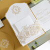 Luxury wedding invitation suite with embossed floral details, ornate monogram design, custom die-cut floral insert, and elegant gold foil accents designed by Sherry Green Designs for planners and sophisticated wedding celebrations