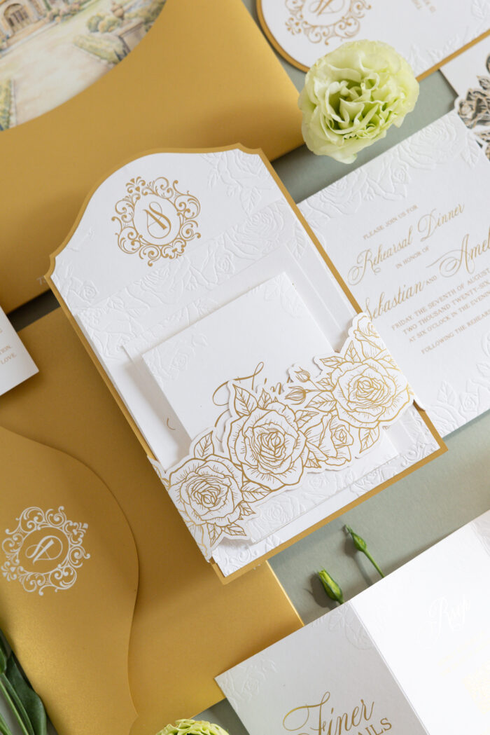 Luxury wedding invitation suite with embossed floral details, ornate monogram design, custom die-cut floral insert, and elegant gold foil accents designed by Sherry Green Designs for planners and sophisticated wedding celebrations