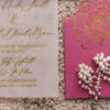 Close-up of vellum wedding invitation with gold foil calligraphy and pink floral card detail by Sherry Designs