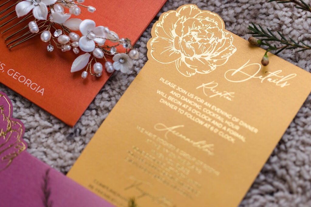 Gold wedding invitation card with floral design and elegant script detail from luxury stationery suite by Inked Green Designs