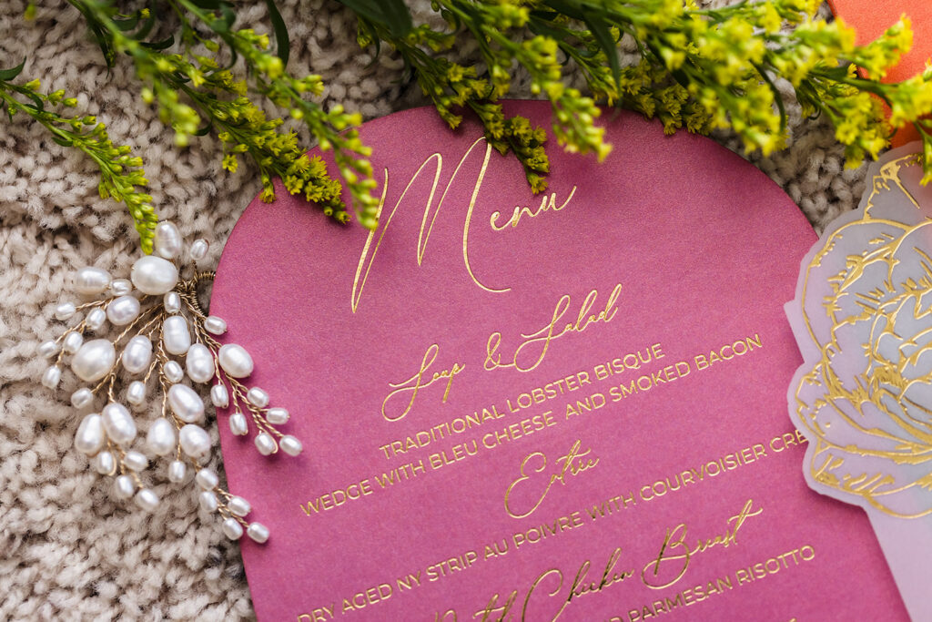 Pink wedding menu card with gold foil lettering and elegant script for luxury reception stationery by Inked Green Designs